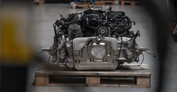 Primer plano de un impecable motor Porsche 992 GT3 con partes internas visibles.